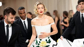 image for Watch Gigi Hadid Require Six Handlers to Make It Up the Met Gala Steps